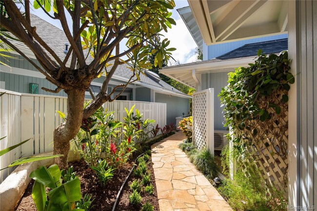 Landscaped entrance with plumeria tree and tropical foliage - 353 Holokai Pl