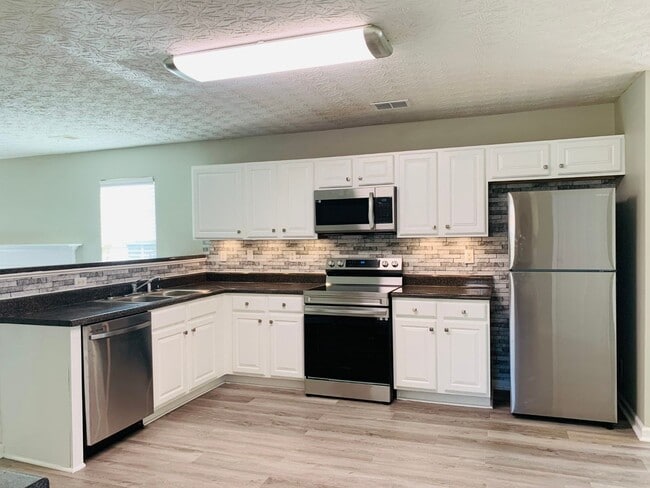 Photo - Prime location! 4 bed, 2.5 bath, LVP floor... House