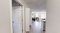 Located at 100 White Ln in Clemson, SC, this single-floor residence offers a thoughtfully designed layout with 2 bedrooms and 3 bathrooms. The open-concept kitchen and living area serves as the heart of the home, featuring light hardwood-style flooring that flows seamlessly throughout the common spaces. The kitchen is outfitted with crisp white cabinetry, granite countertops, stainless steel appliances, and a peninsula with bar seating — ideal for casual dining or entertaining. The living room is bright and welcoming, with large windows that invite natural light and a ceiling fan overhead. Both bedrooms are carpeted for comfort and include ceiling fans, closet storage, and neutral tones that create a calm, functional atmosphere. The primary bedroom offers a generous footprint with ample room for a full furniture arrangement. Each of the three bathrooms is finished with granite-top vanities, white cabinetry, large mirrors, and wood-style flooring, maintaining a consistent and clean aesthetic throughout. Textured ceilings are present across the home, adding architectural character. The overall design emphasizes practicality and comfort, making this Clemson residence a well-rounded and move-in ready space.