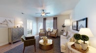 This thoughtfully designed single-floor residence offers a comfortable and stylish living experience across a well-organized floor plan. The living room serves as the heart of the home, featuring warm wood-look flooring, a ceiling fan with light fixture, textured ceilings, and large windows with blinds that allow ample natural light to fill the space. The open layout connects seamlessly to the dining area, making it ideal for both relaxing and entertaining.

The kitchen is a functional highlight, outfitted with rich wood cabinetry, granite countertops, and a full suite of stainless steel appliances including a range, microwave, and refrigerator. A peninsula with seating provides an additional casual dining or workspace option, enhancing the kitchen's versatility.

The residence includes two bedrooms, each offering a calm and restful atmosphere with neutral tones, carpeted flooring, closet storage, and windows that invite natural light. Both bathrooms are clean and well-appointed, each featuring a shower-tub combination, wood vanities with dark countertops, and wood-look flooring that ties cohesively to the rest of the home.

Throughout the residence, a neutral color palette and consistent flooring create a cohesive, inviting ambiance that is both practical and aesthetically pleasing.