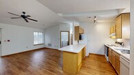 Located at 2128 Meadowland Dr in Sheboygan, Wisconsin, this one-bedroom, one-bathroom home offers a well-designed, single-floor layout with a comfortable and functional living environment. The open-concept kitchen and living room area serves as the heart of the home, featuring warm hardwood flooring, vaulted ceilings, and a ceiling fan. The kitchen is equipped with light oak cabinetry, a built-in peninsula with generous counter space, a range, dishwasher, refrigerator, and a microwave, all complemented by track lighting overhead. A sliding glass door in the living area fills the space with natural light and provides direct access to a private outdoor patio. The spacious bedroom offers plush carpeting, vaulted ceilings, and two large windows that invite ample natural light. The full bathroom features light oak cabinetry, a wide vanity mirror, a tub/shower combo, and hardwood flooring. A dedicated in-unit laundry room houses a full-size washer and dryer alongside built-in shelving for additional storage. Throughout the home, warm wood trim accents and neutral tones create a cohesive and inviting atmosphere, making this Sheboygan residence a practical and comfortable place to call home.