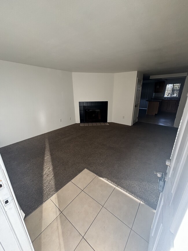 Living room with wood burning fireplace - 1515 W Casino Rd