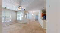 Located on Westlake Road in Fayetteville, NC, this single-floor unit offers a practical and comfortable layout designed to maximize livable space. The open-concept living and dining area is expansive, featuring neutral-toned carpet, a ceiling fan, and multiple windows that invite generous natural light and views of surrounding greenery. A pendant light fixture marks the dining area, which flows seamlessly from the living space and connects directly to the kitchen via a pass-through counter.

The kitchen is well-appointed with warm wood cabinetry, granite-look countertops, a double-basin sink, a black dishwasher, a black refrigerator, and a range, all set on tile flooring. Ample upper and lower cabinet storage adds functionality throughout.

The bedrooms are carpeted and comfortably sized, each featuring windows with blinds that provide natural light and outdoor views. The textured ceilings and neutral wall tones carry throughout the unit for a cohesive feel. Two full bathrooms include tub-shower combinations and tile flooring with brushed nickel hardware accents.

A dedicated utility room with tile flooring houses the water heater, an electrical panel, and shelving, providing added storage and convenience within the unit.