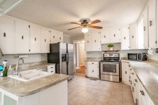 Second view of the kitchen with farmhouse sink, Refrigerator, oven, stovetop, and microwave - 58 Peachtree St