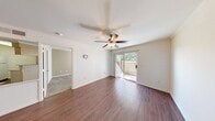 This one-bedroom, one-bathroom unit in McAllen, Texas offers a well-designed single-floor layout that makes efficient use of its space. The living room serves as the heart of the home, featuring rich hardwood-style flooring, a ceiling fan, crown molding, and a sliding glass door that opens to a private outdoor patio, filling the room with natural light and providing a seamless indoor-outdoor connection.

The kitchen is thoughtfully designed with light wood cabinetry, granite countertops, and white appliances including a refrigerator, electric range, and built-in microwave. A peninsula with a granite-topped breakfast bar separates the kitchen from the living area, creating an open and functional layout ideal for everyday living. Crown molding and an overhead soffit add a refined architectural touch.

The bedroom features plush wall-to-wall carpeting, a ceiling fan, and a window with outdoor views, creating a comfortable and private retreat. The full bathroom is well-appointed with a granite-topped vanity, light wood cabinetry, a tub-shower combination with decorative tile accents, a large mirror, and hardwood-style flooring. Adjacent closet space adds practical storage. Throughout the unit, neutral tones and consistent finishes contribute to a clean and cohesive aesthetic.