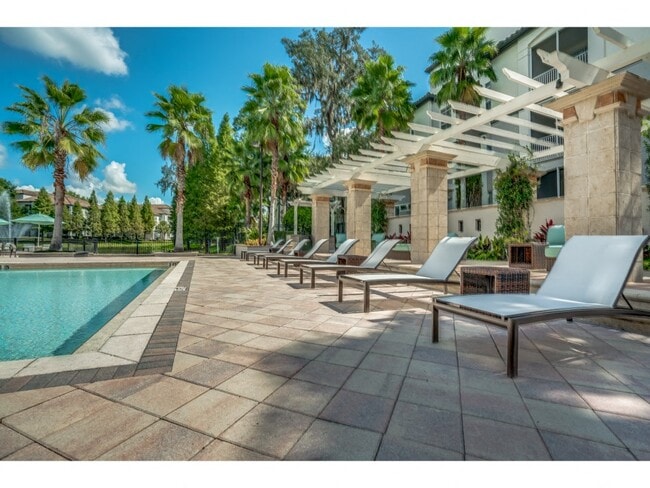 Pool area with lounge seating and umbrellas - Sanctuary at Highland Oaks