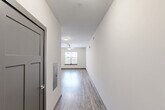 Located at 726 Fulton St in Chattanooga, TN, this one-bedroom, one-bathroom unit offers a well-organized layout across a single floor. Wood-look plank flooring runs throughout the main living areas, lending a clean and contemporary feel. A hallway with a ceiling fan leads from the entry into the open-concept living, dining, and kitchen area, which is bathed in natural light from a street-facing window.

The kitchen is a standout feature, equipped with white shaker-style cabinetry, granite countertops, a white subway tile backsplash, and a full suite of stainless steel appliances including a refrigerator, range, microwave, and dishwasher. Track lighting overhead ensures excellent task illumination.

The bedroom is carpeted for comfort and includes two closets for ample storage. The bathroom is finished with white subway tile surrounding a full soaking tub and shower combination, complemented by clean white walls and tile flooring. A utility room provides additional functional space. The unit also features a neutral white color palette throughout, contributing to a bright and modern ambiance well-suited for everyday living in the heart of Chattanooga.