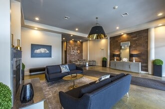 Resident clubhouse featuring lounge seating, entertainment space, and community kitchen - Loft Two Seven