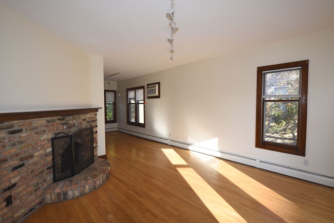 Large living area with high ceiling and hardwood floors - 2432 Stevens Ave