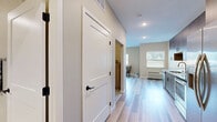 Located at 15315 Maple Island Rd in Burnsville, MN, this one-bedroom, one-bathroom unit offers a thoughtfully designed single-floor layout with a clean, modern aesthetic. The open-concept living room and kitchen area serves as the heart of the home, featuring light wood-style flooring that extends throughout the main living spaces. Large windows fitted with horizontal blinds invite an abundance of natural light, creating a bright and welcoming atmosphere with views of the surrounding greenery.

The kitchen is well-appointed with rich walnut-toned cabinetry, granite countertops, a classic white subway tile backsplash, and a full suite of stainless steel appliances including a range, microwave, dishwasher, and refrigerator — offering both style and functionality.

The bedroom provides a comfortable, cozy retreat finished with soft carpeting and neutral wall tones, offering a calm environment for rest. A dedicated closet adds practical storage to the space.

The bathroom is clean and functional, featuring a full tub and shower combination. The unit's warm, neutral color palette and consistent modern finishes throughout give it a cohesive and inviting character, making it an efficient and stylish place to call home.