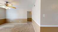 Located at 101 Redwater Rd in Wake Village, TX, this single-story, 2-bedroom, 1-bathroom home offers a practical and comfortable layout across its single floor. A consistent design theme runs throughout, featuring two-tone walls with warm golden-tan lower panels and neutral upper tones, accented by white chair-rail molding and white baseboards.

The living area is carpeted and equipped with a ceiling fan, with a tiled entryway near the front door. Natural light enters through windows fitted with horizontal blinds. The dining area connects to the rest of the home and features tile flooring, French doors that open to an outdoor patio, and a stacked washer and dryer unit tucked into a dedicated alcove.

The galley-style kitchen is efficiently laid out with white cabinetry, light countertops, tile flooring, and includes appliances such as a refrigerator and dishwasher. Both bedrooms are carpeted and feature ceiling fans with light fixtures and windows with blinds. The primary bedroom includes two closets — one of which is a walk-in — offering generous storage. The full bathroom includes a single-sink vanity, toilet, and a tub-shower combination with white tile surround and tile flooring. Two closets throughout the home provide additional storage options.