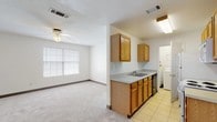 Located at 722 W Carolina St in Tallahassee, FL, this single-story unit offers a practical, well-organized layout suited for comfortable everyday living. The open-plan living and dining area is finished with neutral carpet, a ceiling fan with light fixture, and a multi-pane window that allows natural light to fill the space. This area flows directly into the kitchen, which features warm oak cabinetry — both upper and lower — a double basin sink with a neutral countertop, and tile flooring. Appliances include a coil-burner electric range, an over-the-range microwave, a refrigerator, and a dishwasher. A dedicated laundry area is accessible directly from the kitchen and accommodates a full-size washer and dryer.

The bedrooms are carpeted and include ceiling fans, ample wall space, and closets. Each room benefits from natural light via windows fitted with blinds. The bathroom features tile flooring, a stand-up shower stall, a toilet, and a separate vanity area with an oak cabinet, a neutral countertop, a single basin sink, and a lighted mirror above. Overall, the unit presents a clean, functional interior throughout.