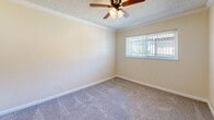 Located at 2509 Edison Ave in Sacramento, California, this single-story 2-bedroom, 1-bathroom home offers a practical and comfortable layout. The space is thoughtfully organized, with all rooms accessible via a central hallway that connects the living areas seamlessly.

The kitchen is well-appointed with white cabinetry, a gas range, a full-size refrigerator, and a sink with dark countertops. Light wood-style flooring runs throughout the kitchen and common areas, and a ceiling fan with integrated lighting adds comfort and warmth to the space. Crown molding provides a clean, finished look.

Both bedrooms feature soft carpeting, ceiling fans, and windows fitted with vertical blinds that allow for natural light and privacy. The primary bedroom includes a large sliding-door closet, offering ample storage. Crown molding and a textured ceiling add subtle architectural character to the bedrooms.

The bathroom is neatly designed with wood-style flooring, a white vanity with a medicine cabinet mirror, a lighted vanity bar, and a tiled shower area. Clean white fixtures and neutral walls give the bathroom a fresh, functional aesthetic.

Overall, the home presents a clean, neutral palette with warm beige tones throughout, creating a welcoming and move-in-ready atmosphere suited for comfortable everyday living.