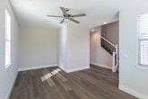 Located at 260 S Main St in Milpitas, CA, this thoughtfully designed three-story home offers 3 bedrooms and 5 bathrooms across a well-distributed layout. The ground floor houses an attached garage with direct interior access. The main living level is the heart of the home, featuring a bright, open living room with light hardwood flooring, a ceiling fan, and glass doors that open to a balcony with scenic views. The kitchen is a standout, showcasing a large island with a white quartz countertop, pendant lighting, gray shaker-style cabinetry, a subway tile backsplash, stainless steel appliances, and a sleek range hood. A dedicated laundry room with overhead cabinetry and natural light adds convenience. The upper floor hosts the bedrooms, each carpeted or finished with hardwood floors and fitted with ceiling fans and windows dressed in wood blinds for ample natural light. The bathrooms are elegantly appointed with gray vanities, white countertops, and framed mirrors. Connecting all three levels are stylish staircases with white-painted railings, ornate wrought iron balusters, and carpeted treads, adding a refined architectural touch throughout the home.
