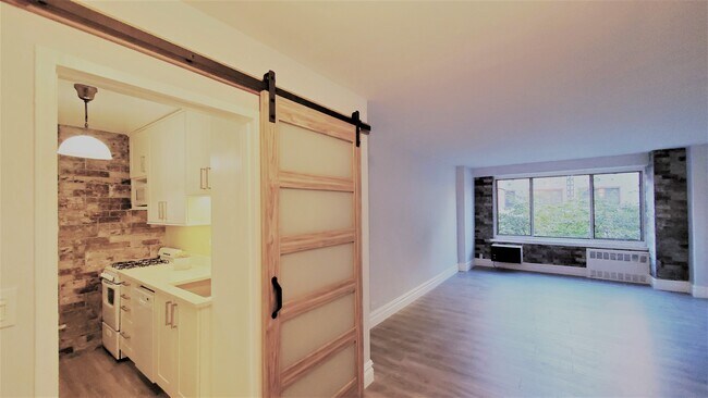 View from entry foyer into kitchen and living room - 400 Central Park W