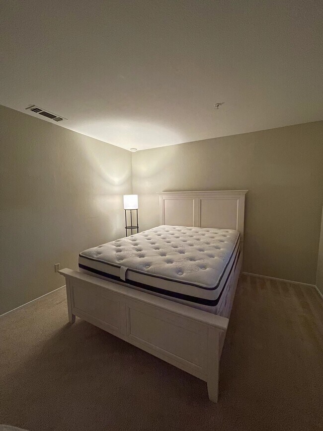 Bedroom with queen side bed and light - 480 Bollinger Canyon Ln Apartments