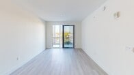 This contemporary 640 square foot apartment offers a well-designed living space with a single bedroom and bathroom. The open-concept layout seamlessly integrates the kitchen and living area, creating a sense of spaciousness. The kitchen features sleek white cabinetry, stainless steel appliances, and ample counter space, perfect for culinary enthusiasts. Light wood flooring throughout adds warmth and continuity to the space.

The 150 square foot bedroom provides a comfortable retreat, complete with a large window offering natural light and outdoor views. The bathroom boasts modern fixtures, including a vanity with storage and a combination bathtub-shower. A hallway and closet offer additional storage solutions.

Large windows and a balcony invite natural light and provide a connection to the outdoors. The apartment's neutral color palette and clean lines create a contemporary ambiance, while ceiling fans and HVAC systems ensure year-round comfort. This efficient layout maximizes every square foot, making it an ideal home for those seeking a modern, low-maintenance living space in an urban setting.