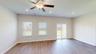 Located in Pooler, GA, this two-story home offers four bedrooms and three bathrooms across a well-designed floor plan. The main level provides the majority of the living space and features an open-concept kitchen and living area. The kitchen is equipped with granite countertops, white shaker cabinetry, a subway tile backsplash, stainless steel appliances, and pendant lighting—a clean, modern aesthetic throughout. The living room features wood-look luxury vinyl flooring, recessed lighting, a ceiling fan, and dual windows that fill the space with natural light. Bathrooms echo the home's design language with granite-topped white vanities and wood-look flooring. The upper level hosts the remaining bedrooms, carpeted for comfort, each with windows providing natural light and access to well-organized closets featuring wire shelving systems. The spacious primary bedroom includes its own closet. Throughout, neutral tones and clean finishes create a bright, cohesive ambiance. Outside, a covered patio extends to a fully fenced, generously sized backyard with lush green lawn—ideal for outdoor enjoyment and privacy.