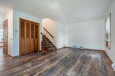Located at 2487 Fiedler Ln in Madison, WI, this three-bedroom, three-bathroom home spans three floors, offering a well-organized and functional layout throughout. The main level welcomes visitors with a bright living room featuring warm hardwood flooring, wood-trimmed windows that invite natural light, a ceiling fan, and a staircase with a classic wood banister. The adjacent combined kitchen and dining area is equipped with rich dark wood cabinetry, granite-style countertops, stainless steel appliances, and hardwood flooring that carries the space together seamlessly. A conveniently located bathroom sits just off the kitchen. The upper floors house three generously sized bedrooms, each with hardwood floors, warm-toned wood window trim, and ample closet space featuring louvered bifold doors. Three full bathrooms with clean, bright finishes serve the home across its floors. The finished basement offers additional living or storage potential, highlighted by warm cedar wood wainscoting and durable terrazzo-style flooring. A utility room rounds out the lower level. Outdoors, the patio provides a pleasant view of the surrounding neighborhood and greenery. With five closets and a practical multi-floor design, this Madison home delivers comfort and versatility throughout.