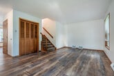 Located at 2487 Fiedler Ln in Madison, WI, this three-bedroom, three-bathroom home spans three floors, offering a well-organized and functional layout throughout. The main level welcomes visitors with a bright living room featuring warm hardwood flooring, wood-trimmed windows that invite natural light, a ceiling fan, and a staircase with a classic wood banister. The adjacent combined kitchen and dining area is equipped with rich dark wood cabinetry, granite-style countertops, stainless steel appliances, and hardwood flooring that carries the space together seamlessly. A conveniently located bathroom sits just off the kitchen. The upper floors house three generously sized bedrooms, each with hardwood floors, warm-toned wood window trim, and ample closet space featuring louvered bifold doors. Three full bathrooms with clean, bright finishes serve the home across its floors. The finished basement offers additional living or storage potential, highlighted by warm cedar wood wainscoting and durable terrazzo-style flooring. A utility room rounds out the lower level. Outdoors, the patio provides a pleasant view of the surrounding neighborhood and greenery. With five closets and a practical multi-floor design, this Madison home delivers comfort and versatility throughout.