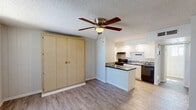 Located at 6320 N 16th St in Phoenix, Arizona, this efficiently designed single-floor unit makes excellent use of its compact footprint. The open living area features light wood-look flooring, vertical blinds allowing ample natural light, a ceiling fan with integrated lighting, and a textured ceiling. A built-in closet with bi-fold doors provides convenient storage directly within the main living space.

The galley-style kitchen is well-appointed with white shaker cabinetry, dark granite countertops, a double stainless steel sink, black appliances including a gas range and refrigerator, and a mosaic tile backsplash — offering strong functionality in a streamlined layout.

The unit includes two bathrooms. The full bathroom features a tub-shower combination with floor-to-ceiling tile accented by vertical mosaic inlays, a white vanity with dark granite countertop, and wood-look tile flooring. The second bathroom provides additional vanity space with dark granite countertops and access to a dedicated walk-in closet with built-in shelving, adding notable storage capacity. Painted brick walls and a small window bring character and light to this secondary space. Throughout the unit, cohesive finishes and updated fixtures contribute to a clean, modern aesthetic.