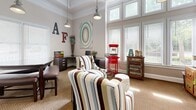 Located at 6115 Abbotts Bridge Rd in Johns Creek, GA, this single-room office space delivers a surprisingly dynamic and well-designed environment. The room features notably high ceilings adorned with elegant crown molding, which lend an open, airy feel well beyond what the footprint might suggest. Industrial-style pendant lights hang from above, providing warm, focused illumination throughout the space.

A wall of tall, multi-pane windows dressed with white blinds lines one side of the room, flooding the interior with generous natural light and offering views of the surrounding greenery. The textured, neutral-toned carpet anchors the space and complements the warm, beige wall palette.

The office is thoughtfully arranged to serve multiple functions. A dedicated work area features a dark wood corner desk and an ergonomic chair alongside a printer station, making it fully equipped for professional use. A comfortable seating arrangement with bold, multi-striped accent chairs and an eclectic patchwork side table creates an inviting lounge area suitable for meetings or informal gatherings. A rustic, distressed wood credenza along one wall serves as a coffee station, adding a welcoming, hospitality-oriented touch. Decorative elements, including abstract wall art, ornamental dried branches, and vintage signage lettering, contribute to the space's distinct, eclectic character.