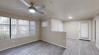 Located at 4909 West Joshua Boulevard in Chandler, Arizona, this single-story 2-bedroom, 2-bathroom home offers a thoughtfully designed layout with modern finishes throughout. The living area features neutral-toned walls, wood-look luxury vinyl flooring, and a ceiling fan with light fixture, creating a bright and comfortable atmosphere. Large windows dressed with vertical blinds allow natural light to fill the space, while a sliding glass door opens to a private patio with outdoor views.

The kitchen is well-equipped with white shaker-style cabinetry, granite-look countertops, stainless steel appliances including a dishwasher, microwave, and refrigerator, and a peninsula that provides additional prep space and overlooks the living area. Both bathrooms feature white vanity cabinetry with granite-look countertops, large mirrors, and a tub-shower combination with clean white surrounds.

The two bedrooms are generously sized, with the primary bedroom offering direct access to one of the bathrooms. Each bedroom includes a ceiling fan, wood-look flooring, and ample closet space. Additional conveniences include a dedicated laundry area and utility room. Crown molding accents select rooms, adding a refined touch to the overall design.