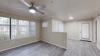 Located at 4909 West Joshua Boulevard in Chandler, Arizona, this single-story 2-bedroom, 2-bathroom home offers a thoughtfully designed layout with modern finishes throughout. The living area features neutral-toned walls, wood-look luxury vinyl flooring, and a ceiling fan with light fixture, creating a bright and comfortable atmosphere. Large windows dressed with vertical blinds allow natural light to fill the space, while a sliding glass door opens to a private patio with outdoor views.

The kitchen is well-equipped with white shaker-style cabinetry, granite-look countertops, stainless steel appliances including a dishwasher, microwave, and refrigerator, and a peninsula that provides additional prep space and overlooks the living area. Both bathrooms feature white vanity cabinetry with granite-look countertops, large mirrors, and a tub-shower combination with clean white surrounds.

The two bedrooms are generously sized, with the primary bedroom offering direct access to one of the bathrooms. Each bedroom includes a ceiling fan, wood-look flooring, and ample closet space. Additional conveniences include a dedicated laundry area and utility room. Crown molding accents select rooms, adding a refined touch to the overall design.