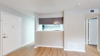 Located at 4323 Winters Chapel Rd in Doraville, Georgia, this single-story unit presents a clean, updated interior with a cohesive neutral color palette throughout. Light wood-style flooring runs continuously across the living areas and bedrooms, lending a sense of warmth and visual continuity to the space.

The living area is open and well-lit, benefiting from a sliding glass door dressed with vertical blinds that invites natural light and provides outdoor access. A pass-through window connects this area to the kitchen, creating an open, communicative layout between the two spaces. The kitchen is well-appointed with gray shaker-style cabinetry, white quartz countertops, a subway tile backsplash, a double stainless steel sink, a dishwasher, and a freestanding range. A pantry closet is conveniently accessible directly from the kitchen.

The bedrooms each feature light wood flooring, ceiling fans with integrated lighting, textured ceilings, and windows with blinds that allow for natural light and privacy control. One bedroom offers direct exterior access through a glass door.

The bathroom includes a full tub-and-shower combination with floor-to-ceiling taupe tile surround and chrome fixtures, complemented by wood-style flooring. Throughout the unit, white baseboards and neutral gray walls provide a polished, move-in-ready aesthetic.