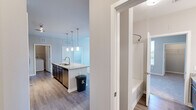 Located in Parker, Colorado, this well-appointed 2-bedroom, 2-bathroom residence offers a thoughtfully designed single-level layout with modern finishes throughout. The open-concept kitchen serves as the heart of the home, showcasing a large granite-topped island with an undermount sink, dark espresso cabinetry, a white subway tile backsplash, and a full suite of stainless steel appliances including a French door refrigerator, electric range, and microwave. Stylish pendant lighting illuminates the island, while hardwood-style flooring flows throughout the main living and kitchen areas. The spacious primary bedroom features soft carpeting, a ceiling fan, and a window that welcomes natural light and outdoor views. Its en-suite bathroom is appointed with granite countertops, dark cabinetry, a tub-shower combination, and wood-style flooring. The second bathroom mirrors this refined aesthetic. Carpeted bedrooms offer a comfortable, quiet retreat. A dedicated laundry room provides added convenience with space for a full-size washer and dryer. The clean, neutral color palette and consistent finishes create a cohesive, move-in-ready atmosphere throughout this well-organized Parker home.