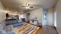Located at 1441 E Omaha St in Broken Arrow, Oklahoma, this 2-bedroom, 2-bathroom single-floor unit offers a well-organized and functional layout. The open-concept main living area seamlessly connects the living room, dining area, and kitchen, creating a spacious and cohesive gathering space. Hardwood-style flooring runs throughout the main areas, complemented by ceiling fans that add both style and comfort. The living room features a large window that brings in natural light and provides outdoor views, while arched transitions add a subtle architectural detail throughout.

The kitchen is well-appointed with rich dark-stained cabinetry, granite-style countertops, a stainless steel appliance suite including a refrigerator, range, microwave, and dishwasher, and a deep sink — ideal for everyday cooking and entertaining.

Both bedrooms are carpeted and include ceiling fans and windows. The spacious primary bedroom features direct access to a dedicated closet and a private en-suite bathroom. The bathrooms are finished with dark cabinetry vanities and hardwood-style flooring, with one offering a tub-shower combination. Additional highlights include a hallway with ample closet storage, an in-unit laundry area, and a private patio perfect for outdoor relaxation.