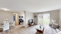 Located at 6 Sussex Rd in Newark, Delaware, this two-bedroom, one-bathroom residence offers a practical and well-designed single-floor layout. The open living area is bright and inviting, featuring light wood-style flooring, neutral gray walls, and a sliding glass door that fills the space with natural light while providing views of the surrounding greenery. A wall-mounted air conditioning unit ensures year-round comfort in the living space.

The galley-style kitchen is thoughtfully outfitted with white shaker cabinetry, light stone countertops, a white subway tile backsplash, and a full suite of stainless steel appliances including a range, microwave, dishwasher, and refrigerator. Light wood flooring and a window overlooking the exterior keep the kitchen bright and functional.

The primary bedroom offers a generous footprint with plush carpeting, a wall air conditioning unit, a closet, and a window that admits ample natural light. The second bedroom is cozily carpeted and features a window with outdoor views, making it well-suited as a guest room or home office. Both bedrooms connect conveniently via a hallway.

The full bathroom is clean and efficiently designed, featuring a tub-shower combination, vanity with storage, and tile flooring. Overall, this residence provides a comfortable and functional living environment in a convenient Newark location.