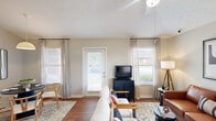 Located at 7900 Berryhill Pl in Montgomery, Alabama, this single-floor, three-bedroom, two-bathroom home offers a well-organized layout with a comfortable and functional design throughout. The living room is a standout space, featuring vaulted ceilings that add a sense of height and openness, wood-style flooring, and windows that bring in natural light. It provides a welcoming entry point into the home. The kitchen is equipped with white cabinetry accented by wood-tone trim, a coil-top range, built-in microwave, refrigerator, and a double sink set into a peninsula-style counter. Light tile flooring runs throughout, and ample upper and lower cabinet storage makes the space highly practical. The three bedrooms are carpeted and offer a warm, quiet atmosphere. The primary bedroom includes a window with outdoor views and a textured ceiling. The additional bedrooms each include closets with double doors, providing generous storage. Both bathrooms feature tile flooring, wood-trimmed vanities with white countertops, and tub-shower combinations. One bathroom includes a well-lit vanity mirror with a strip light fixture. Overall, the home presents a neutral, clean palette with consistent finishes that create a cohesive and livable environment throughout.
