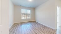 Located at 4300 Frederick Ave in Baltimore, MD, this thoughtfully designed 2-bedroom, 2-bathroom residence offers a clean, modern aesthetic across a single level. The open-concept kitchen and living area serves as the heart of the home, featuring rich dark brown shaker-style cabinetry, a white quartz countertop island with pendant lighting, a white subway tile backsplash, and a full suite of stainless steel appliances including a gas range, built-in microwave, dishwasher, and refrigerator. Light hardwood-style flooring flows seamlessly throughout the space, complementing the neutral color palette. Both bedrooms are bright and well-proportioned, each benefiting from large windows that invite natural light and offer outdoor views. The primary bedroom includes access to a dedicated walk-in closet outfitted with wire shelving and hanging rods. The two bathrooms are finished with consistent design elements, including dark wood vanities, white quartz countertops, undermount sinks, large mirrors, hexagonal tile flooring, and overhead cabinet storage. The overall ambiance is contemporary and clean, with a cohesive material palette that balances functionality and modern style throughout.