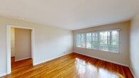 Located at 336 N Garfield Ave in Montebello, California, this single-floor home offers a clean, functional layout with consistent design elements throughout. Gleaming hardwood floors run across the living areas and bedrooms, reflecting natural light and lending warmth to every room.

The living area is bright and open, anchored by a wide bank of windows fitted with horizontal blinds that allow for adjustable natural light and views of the surrounding greenery. A second living or dining space features the same hardwood flooring and a welcoming front entry door with a paneled design.

The bedrooms are comfortably sized, with one room featuring corner windows and a ceiling fan with integrated lighting, enhancing both airflow and comfort. The neutral wall tones throughout create a calm, versatile backdrop.

The kitchen is well-appointed with light maple cabinetry, dark granite countertops, a stainless steel over-the-range microwave, a black gas range, and a stainless steel sink positioned beneath a window. The combination of dark stone surfaces and warm wood cabinets gives the kitchen a practical yet polished character.

The bathroom includes a wood-toned vanity with dark granite countertops, an oval undermount sink, brushed nickel fixtures, a large mirror, and a full tub-shower combo with white tile surround. The overall layout of the home is efficient and well-connected, making it a comfortable and move-in-ready space.