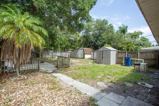 spacious backyard with plenty storage sheds. - 4911 23rd St W