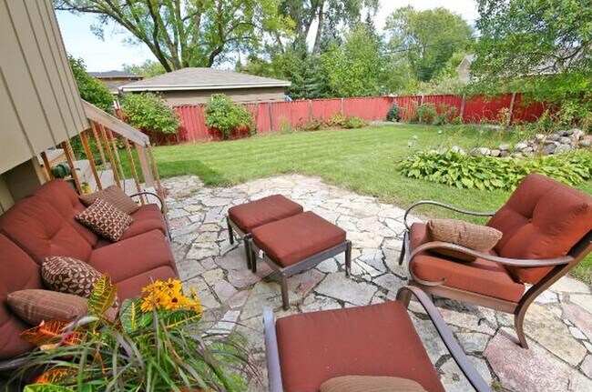 Fenced, landscaped backyard with stone patio - 5813 Tracy Avenue