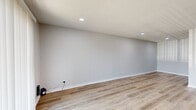 Located at 4020 S 130th East Ave in Tulsa, Oklahoma, this one-bedroom, one-bathroom unit offers a thoughtfully designed single-floor layout with a clean, modern aesthetic throughout. Light-toned luxury vinyl plank flooring runs continuously across every room, complemented by crisp white baseboards and a soft neutral color palette that enhances the sense of openness and brightness.

The living room is a generous, open space illuminated by recessed lighting and a large sliding glass patio door that invites natural light and provides direct outdoor access. The seamless flow from the living area into the hallway connects all spaces efficiently.

The bedroom is a well-proportioned retreat featuring a window for natural light, recessed ceiling lighting, and a door leading to a dedicated walk-in closet outfitted with wire shelving for ample storage.

The bathroom is finished with rich dark cherry wood cabinetry, granite-topped vanity, and a full soaking tub with an overhead shower. The tub surround is clad in large-format marble-look tile with brushed nickel fixtures, lending a polished, upscale feel. Wood-look tile flooring ties the space together cohesively.

A dedicated laundry room with washer/dryer hookups and wire shelving adds everyday convenience, rounding out this well-appointed and efficiently designed unit.