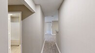 Located at 8242 Durelee Ln in Douglasville, GA, this single-floor residence offers 2 bedrooms and 3 bathrooms within a well-organized floor plan. Light-toned luxury vinyl plank flooring runs throughout, complemented by neutral beige walls and crisp white trim, creating a clean and cohesive aesthetic.

The open living area is generously sized, featuring a ceiling fan with light fixture and windows that allow natural light to fill the space. The galley-style kitchen is efficiently designed with gray cabinetry, speckled countertops, a stainless steel sink, and black appliances including a range and refrigerator, alongside a dishwasher. A pantry closet is conveniently located at the end of the kitchen corridor.

Both bedrooms are well-proportioned and feature ceiling fans, closets with double doors, and windows providing natural light. The primary bedroom offers a notable amount of floor space. The bathrooms are appointed with gray vanity cabinetry, speckled countertops, large mirrors, and tub-shower combinations. Two hallways connect the rooms, and two closets provide additional storage. Textured ceilings are present throughout the home, adding a classic residential finish.