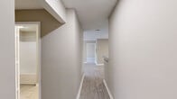 Located at 8242 Durelee Ln in Douglasville, GA, this single-floor residence offers 2 bedrooms and 3 bathrooms within a well-organized floor plan. Light-toned luxury vinyl plank flooring runs throughout, complemented by neutral beige walls and crisp white trim, creating a clean and cohesive aesthetic.

The open living area is generously sized, featuring a ceiling fan with light fixture and windows that allow natural light to fill the space. The galley-style kitchen is efficiently designed with gray cabinetry, speckled countertops, a stainless steel sink, and black appliances including a range and refrigerator, alongside a dishwasher. A pantry closet is conveniently located at the end of the kitchen corridor.

Both bedrooms are well-proportioned and feature ceiling fans, closets with double doors, and windows providing natural light. The primary bedroom offers a notable amount of floor space. The bathrooms are appointed with gray vanity cabinetry, speckled countertops, large mirrors, and tub-shower combinations. Two hallways connect the rooms, and two closets provide additional storage. Textured ceilings are present throughout the home, adding a classic residential finish.