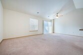 Located at 2864 Pleasant View Rd in Middleton, WI, this two-bedroom, one-bathroom residence offers a well-designed single-floor layout that maximizes comfort and functionality. The open-concept living and dining area is highlighted by vaulted ceilings and a ceiling fan, creating an airy, spacious atmosphere. Large windows allow natural light to fill the room, which features plush wall-to-wall carpeting and a sliding glass door providing additional access and light.

The kitchen is thoughtfully designed with rich cherry-toned cabinetry, granite-look countertops, tile flooring, and a full suite of white appliances including a refrigerator, range, and built-in microwave. A peninsula with a sink and breakfast bar connects the kitchen to the living area, making it ideal for both cooking and entertaining.

Both bedrooms are carpeted and offer natural light through window treatments with blinds. The primary bedroom is a generous size with ample space for furnishings. The full bathroom features a rich wood vanity with a wide mirror, a tub/shower combo, tile flooring, and stylish chrome fixtures.

A dedicated laundry room houses a full-size washer and dryer alongside a water heater, adding convenience to everyday living. A closet completes the thoughtful layout of this well-appointed Middleton residence.