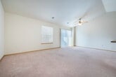 Located at 2864 Pleasant View Rd in Middleton, WI, this two-bedroom, one-bathroom residence offers a well-designed single-floor layout that maximizes comfort and functionality. The open-concept living and dining area is highlighted by vaulted ceilings and a ceiling fan, creating an airy, spacious atmosphere. Large windows allow natural light to fill the room, which features plush wall-to-wall carpeting and a sliding glass door providing additional access and light.

The kitchen is thoughtfully designed with rich cherry-toned cabinetry, granite-look countertops, tile flooring, and a full suite of white appliances including a refrigerator, range, and built-in microwave. A peninsula with a sink and breakfast bar connects the kitchen to the living area, making it ideal for both cooking and entertaining.

Both bedrooms are carpeted and offer natural light through window treatments with blinds. The primary bedroom is a generous size with ample space for furnishings. The full bathroom features a rich wood vanity with a wide mirror, a tub/shower combo, tile flooring, and stylish chrome fixtures.

A dedicated laundry room houses a full-size washer and dryer alongside a water heater, adding convenience to everyday living. A closet completes the thoughtful layout of this well-appointed Middleton residence.