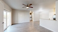 This thoughtfully designed 1-bedroom, 1-bathroom residence offers a comfortable and functional single-floor layout. The open-concept living and dining area is bright and welcoming, featuring light-toned wood-style flooring, neutral walls, and a ceiling fan with light kit. Sliding glass doors provide direct access to a private balcony, allowing natural light to fill the space.

The kitchen is equipped with crisp white shaker-style cabinetry, granite-look countertops, and black appliances including a refrigerator, range, over-the-range microwave, and dishwasher. A chandelier overhead adds a refined touch to the adjacent dining area.

The bedroom offers plush wall-to-wall carpeting, a ceiling fan, and a window with blinds that brings in ample natural light. A dedicated closet provides convenient storage.

The bathroom features tile flooring, a combination tub and shower, a granite-topped vanity with white cabinetry, and a small window for ventilation and light. A laundry area with washer and dryer hookups is also included within the unit. Clean finishes and a cohesive neutral palette throughout give the space a modern, move-in-ready appeal.