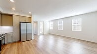 This 830-square-foot, single-story apartment at 30950 Hanover Ln in Menifee, California offers a well-organized 2-bedroom, 1-bathroom layout with modern finishes throughout. The open-concept living room features light wood-style flooring, neutral walls, and multiple windows with blinds that fill the space with natural light, along with a glass door providing direct access to a private balcony. The kitchen is equipped with taupe shaker-style cabinetry, a white tile backsplash, quartz-style countertops, a stainless steel sink, and a full suite of stainless steel appliances including a gas range, microwave, dishwasher, and refrigerator. Recessed lighting and light wood flooring complete the kitchen's clean, contemporary aesthetic. An in-unit stacked washer and dryer is conveniently located off the hallway. Both bedrooms feature plush neutral carpeting and windows with blinds that allow natural light and community views. The primary bedroom measures 150 square feet and includes a dedicated closet with wire shelving and hanging rods. The full bathroom offers a vanity with taupe cabinetry, a tiled tub-shower combo, and wood-style flooring. A second closet provides additional storage. The unit's cohesive neutral palette and modern finishes create a clean, move-in-ready living environment.