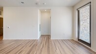 Located at 1200 Duff Dr in Fort Collins, Colorado, this single-story, 3-bedroom, 2-bathroom home offers a clean, modern aesthetic with thoughtfully designed living spaces. Light wood-look flooring runs continuously throughout, complemented by crisp white walls and recessed lighting that create a bright, cohesive atmosphere.

The open-concept kitchen and living area serves as the heart of the home. The kitchen is well-appointed with flat-front light wood cabinetry, a white subway tile backsplash, stainless steel appliances, and a spacious central island topped with granite countertops — ideal for both cooking and casual dining.

The three bedrooms feature the same durable wood-look flooring and neutral walls. Each room benefits from natural light through blinded windows with exterior views, and the primary bedroom includes a dedicated walk-in closet outfitted with wire shelving systems for organized storage.

The two bathrooms are finished with granite-topped light wood vanities and wood-look flooring. The primary bathroom features a glass-enclosed walk-in shower, while the secondary bathroom offers a full shower-tub combo — both reflecting a consistent, contemporary design language. A hallway connects the bedroom wing, completing this efficiently laid-out and move-in-ready home.