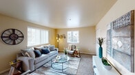 This single-story residence on NE Black Bear Street in Prineville, Oregon, offers a well-designed layout with a cohesive, modern aesthetic carried throughout each room. The living area is finished with plush carpet and features multiple windows dressed with vertical blinds, allowing generous natural light and views of the surrounding neighborhood. Warm beige walls and smooth ceilings contribute to the space's welcoming atmosphere.

The kitchen is outfitted with rich dark wood cabinetry, granite-style countertops, wood-look vinyl plank flooring, recessed lighting, and black appliances including a range, microwave, and refrigerator. Adjacent to the kitchen, the dining area accommodates a full-sized table and is highlighted by a pendant chandelier and a large window.

Two bedrooms offer comfortable proportions, each with windows and neutral tones. The bathrooms are finished with matching dark wood vanities, granite-style countertops, and wood-look flooring. One bathroom features a walk-in shower, while the other includes a soaking tub with shower. The consistent use of warm neutrals and quality finishes throughout creates a cohesive and functional living environment.