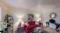 This 1-bedroom, 1-bathroom residence is thoughtfully arranged across a single floor, making efficient use of its space. The living room serves as the heart of the home, featuring soft carpet flooring, neutral walls, and multiple windows that allow natural light to fill the room. A dedicated sitting nook near a window provides a cozy retreat, while an entryway area with built-in architectural detailing adds character to the space.

The dining area is tucked conveniently off the living room, offering a defined space for meals with its own window and overhead lighting. The galley-style kitchen features warm wood cabinetry lining both sides, white appliances including a refrigerator, stove, and dishwasher, light countertops, and easy-care flooring — providing a functional and organized cooking space.

The bedroom is generously sized with carpet flooring, multiple windows that invite natural light, and access to a closet. The full bathroom includes a tiled shower-tub combination and hardwood-style flooring, completing the unit's practical layout. Throughout the residence, a consistent neutral color palette and carpet flooring create a cohesive and comfortable living environment.