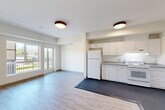 Located at 2905 Santa Rosa Ave in Santa Rosa, CA, this single-floor, 2-bedroom, 2-bathroom residence offers a well-organized layout designed for comfortable everyday living. The open-concept great room seamlessly combines the living, dining, and kitchen areas into one bright, airy space. Light wood-style flooring flows throughout the main living area, while flush-mount ceiling fixtures provide consistent overhead lighting. Sliding glass doors lead to a private balcony offering pleasant outdoor views, including surrounding greenery and distant hillside scenery.

The kitchen is efficiently designed with ample white cabinetry, gray stone-style countertops, and white appliances including a refrigerator, electric range, and dishwasher. Dark vinyl flooring grounds the kitchen zone and visually distinguishes it from the living area.

Both bedrooms feature plush carpeting and generous natural light through large windows. The second bedroom includes a mirrored sliding closet door and hillside views. The primary bedroom offers access to a dedicated closet with wire shelving for organized storage.

The two bathrooms are clean and functional, each featuring a pedestal sink, toilet, wall-mounted storage cabinet, and mirror. One bathroom includes a full soaking tub. A hallway connects all rooms, completing this practical and well-appointed residence.