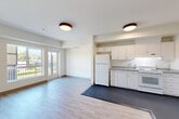 Located at 2905 Santa Rosa Ave in Santa Rosa, CA, this single-floor, 2-bedroom, 2-bathroom residence offers a well-organized layout designed for comfortable everyday living. The open-concept great room seamlessly combines the living, dining, and kitchen areas into one bright, airy space. Light wood-style flooring flows throughout the main living area, while flush-mount ceiling fixtures provide consistent overhead lighting. Sliding glass doors lead to a private balcony offering pleasant outdoor views, including surrounding greenery and distant hillside scenery.

The kitchen is efficiently designed with ample white cabinetry, gray stone-style countertops, and white appliances including a refrigerator, electric range, and dishwasher. Dark vinyl flooring grounds the kitchen zone and visually distinguishes it from the living area.

Both bedrooms feature plush carpeting and generous natural light through large windows. The second bedroom includes a mirrored sliding closet door and hillside views. The primary bedroom offers access to a dedicated closet with wire shelving for organized storage.

The two bathrooms are clean and functional, each featuring a pedestal sink, toilet, wall-mounted storage cabinet, and mirror. One bathroom includes a full soaking tub. A hallway connects all rooms, completing this practical and well-appointed residence.