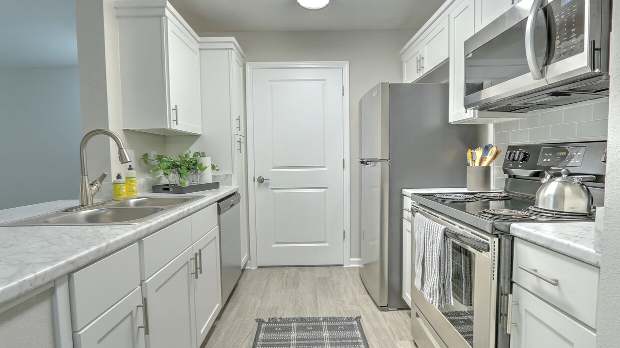 Discover designer kitchen elegance with ample storage in our updated kitchens. - The Grays at Old Town